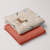 Folded Dog Park muslin swaddle and terra cotta baby muslin blanket set